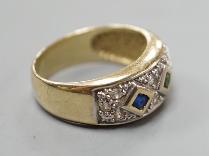 A modern 375 yellow metal and four colour cubic zirconia set dress ring, size O, gross weight 4.6 grams.